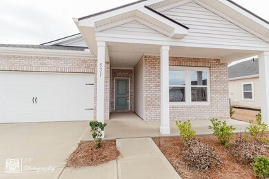 View of front of property featuring a garage and c