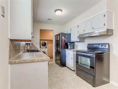 Kitchen featuring stacked washer and clothes dryer