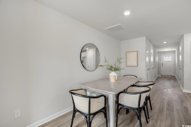 Dining space with light hardwood / wood-style floo
