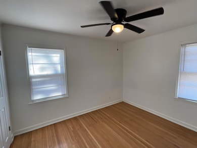 Unfurnished room with ceiling fan and wood-type fl