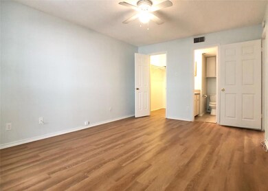 Unfurnished bedroom with a walk in closet, light 