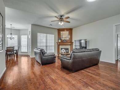 Living room featuring ceiling fan with notable cha
