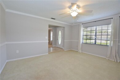 The formal living room is spacious with a large wi