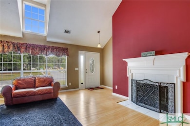 Gracious Entry with gleaming wood floors and a bea