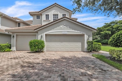 View of front of house featuring a garage, decorative driveway, stucco siding, and a tiled roof