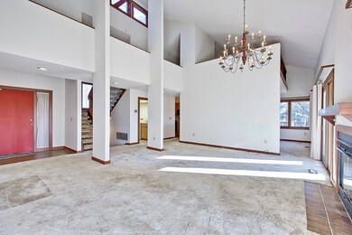 Vaulted living room bathed in light from clear sto