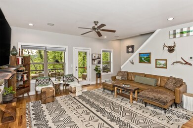 A treehouse perspective is visible from every vantage point in the main level living area.  Through the canopy are views of the French Broad River and Biltmore Estate.