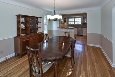 Dining space featuring light hardwood floors and an inviting chandelier