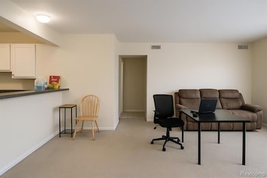 Office with light colored carpet and baseboards