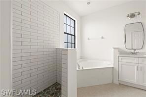 Full bathroom with vanity, a bath, and a walk in shower