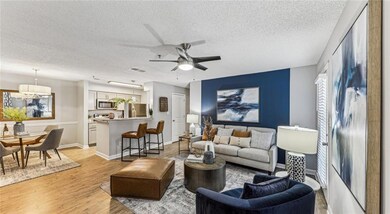 Living room featuring ceiling fan with notable cha