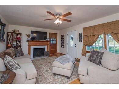 Large living room with hardwood floors, wood trim,