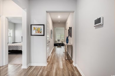 Hallway with wood finished floors and baseboards