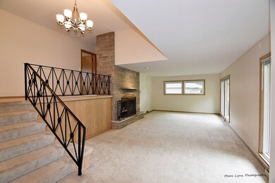 Large living room with a beautiful limestone firep
