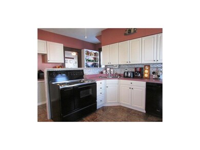 Main floor kitchen with custom cabinets, tile and 