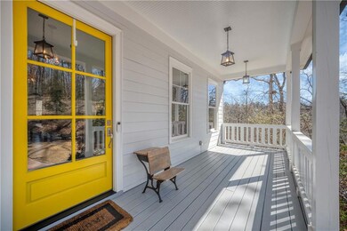 Wooden terrace featuring covered porch.