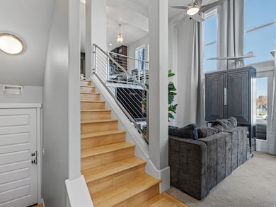 Stairway with a high ceiling and wood finished floors
