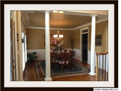 Dining room with chair rail and columns.