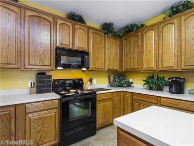 Kitchen. Room for several cooks! Kitchen island with more cabinet space.