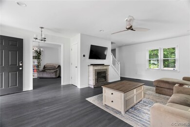 Living room featuring ceiling fan with notable cha
