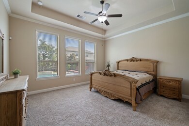 Spacious and sunlit, this primary bedroom features