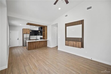 Unfurnished living room featuring light wood finished floors, a sink, visible vents, recessed lighting, and ceiling fan