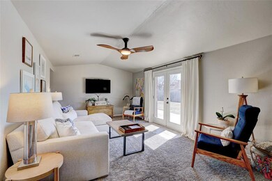 Carpeted living room featuring vaulted ceiling, ce