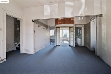Unfurnished room featuring dark colored carpet