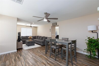 Dining room featuring ceiling fan, dark wood-style