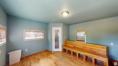 Bedroom with light wood finished floors and baseboards