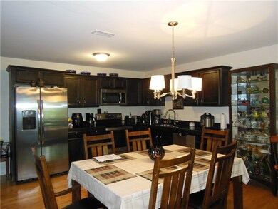 Stainless appliances and nice cabinetry that compl