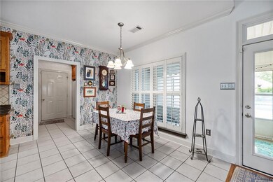 Breakfast area off the kitchen enjoys a bright view of the patio and pool.