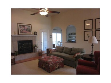 Living Room. hardwood flooring under the area rug, door to covered and screened deck.