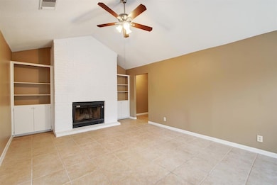 Unfurnished living room with ceiling fan, built i