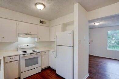 Kitchen featuring white appliances, under cabinet
