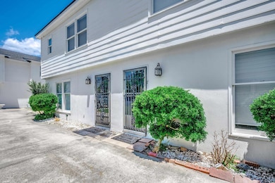 Doorway to property featuring stucco siding