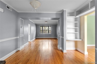 Spare room featuring ornamental molding, a notable