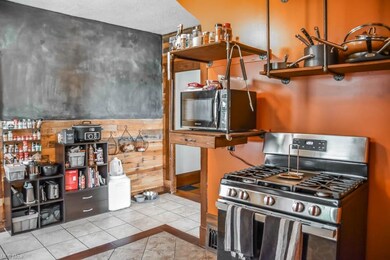 Kitchen has a chalkboard wall and pallet accent wa