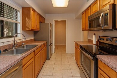 Kitchen with wood cabinets and stainless appliance