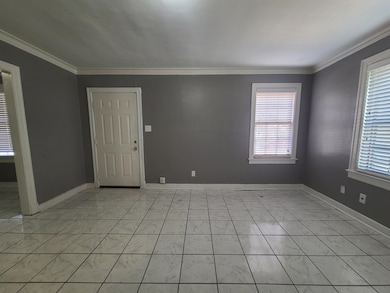 Spare room featuring baseboards and ornamental mol