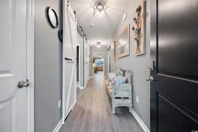 Hallway featuring updated luxury vinyl plank floor