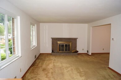 Living room features a log burning fire place and 