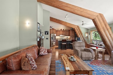 Living room featuring wood finished floors and a ceiling fan