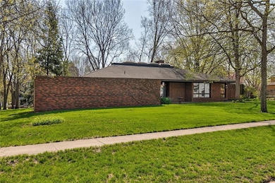 Front of home with brick wall creating a courtyard