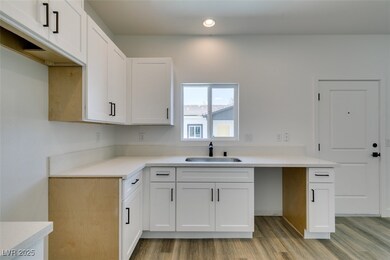 Kitchen with light wood-type flooring, white cabin