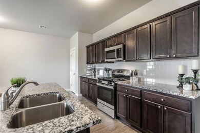Kitchen featuring light stone counters, stainless 