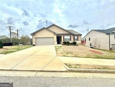 View of front of house with a front lawn, stone siding, an attached garage, and concrete driveway