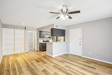 Spacious living area featuring built in shelving.