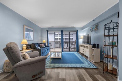 Living room featuring wood finished floors and ornamental molding