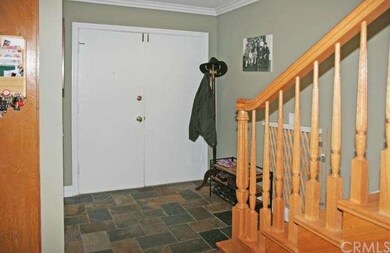 Double Entry Doors Open to Slate Foyer and Solid H